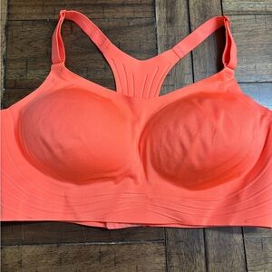 New with tags Women’s coral/orange in color sports bra.